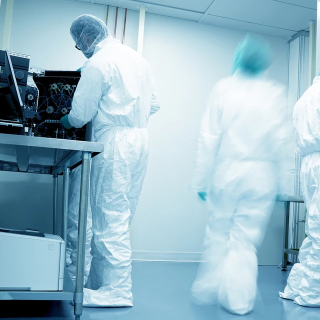 GMP factory workers in white suits