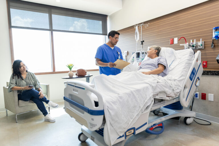 Adult daughter listens carefully while the doctor talks with her mom